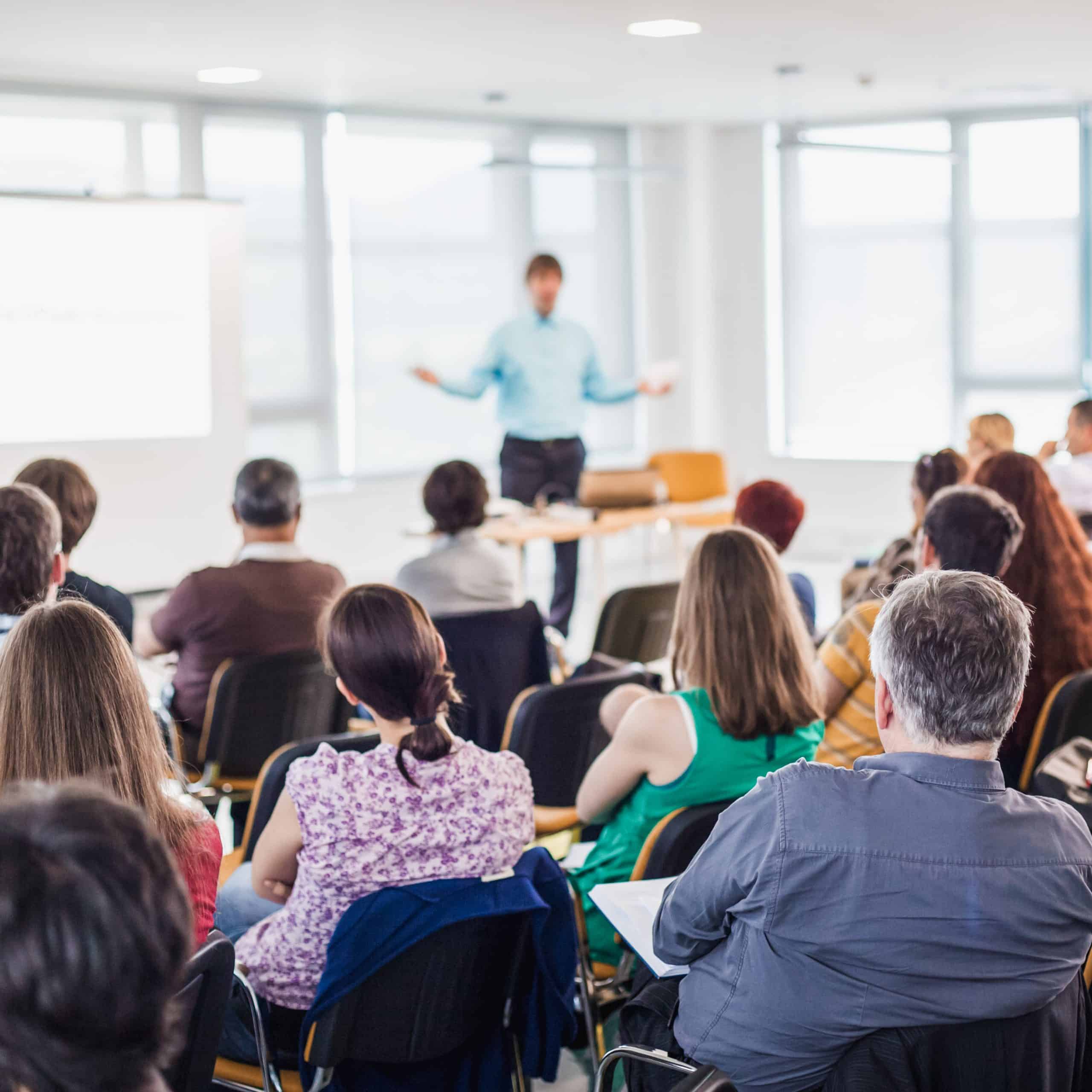 speaker giving presentation business conference scaled